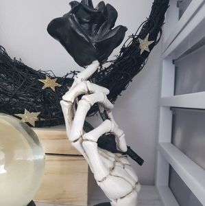 Skeleton hand with black rose